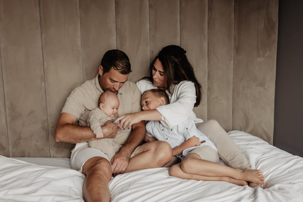 ouders met pasgeboren baby tijdens newbornshoot thuis