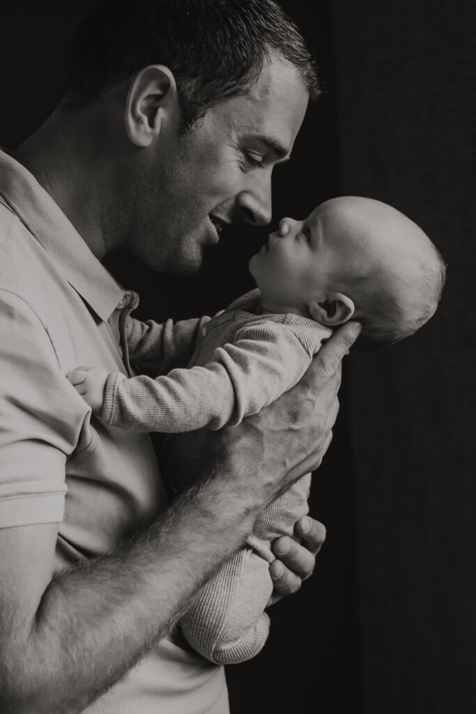 ouders kijken liefdevol naar huilende baby – wat als baby huilt fotoshoot